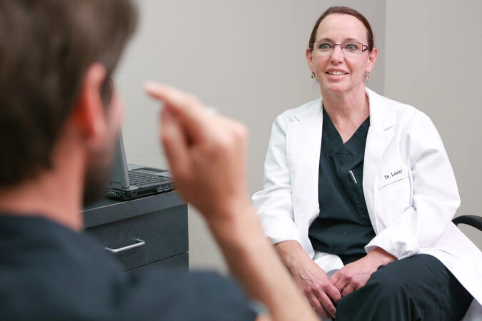 Dr. Shelly Lovitt consulting with a RESTORE patient